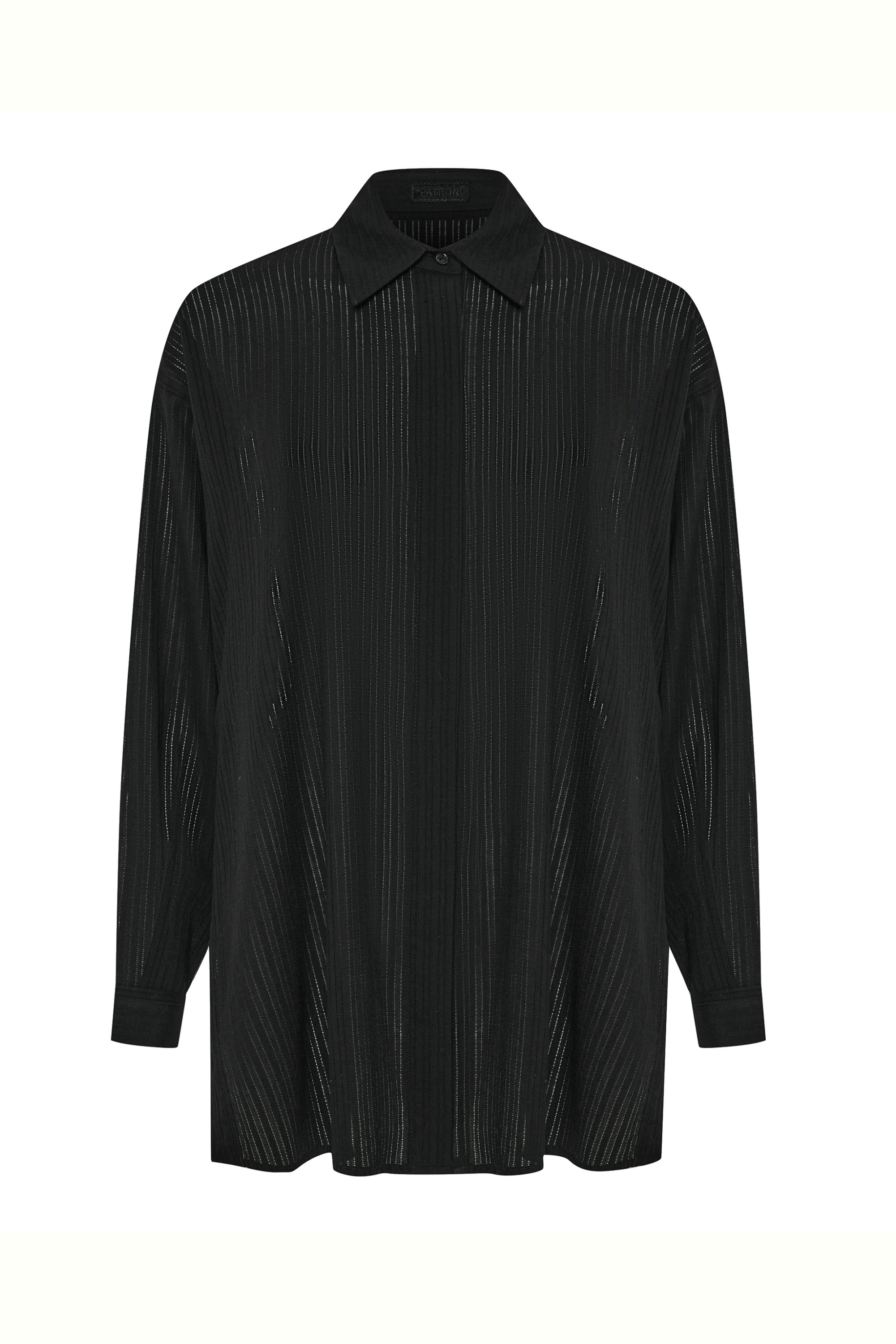 The shirt is cut in a relaxed silhouette with side seams finished by delicate button detailing—an understated nod to utility and ease.&nbsp;

